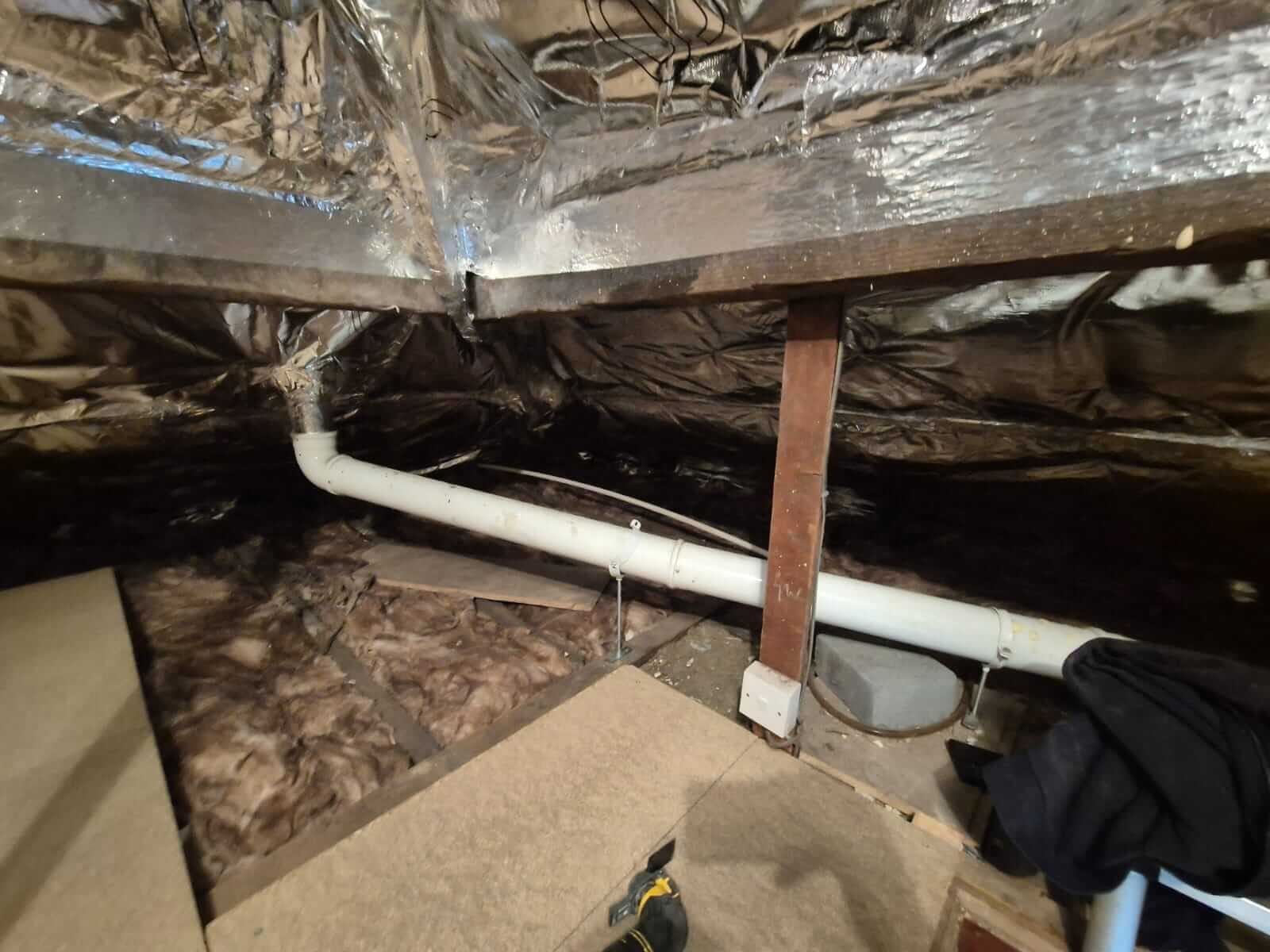 Boarded loft with foil insulation and storage boxes